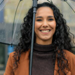 Woman smiling in the rain in Waterford and [test_shortcode]